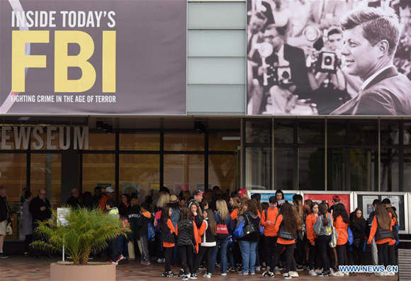 Visitors line under a poster of former U.S. President John F. Kennedy to enter the Newseum in Washington D.C., the United States, on Oct. 26, 2017. The U.S. National Archives is set to release on Thursday the previously classified files related to former President John F. Kennedy's assassination more than half a century ago. (Xinhua/Yin Bogu)