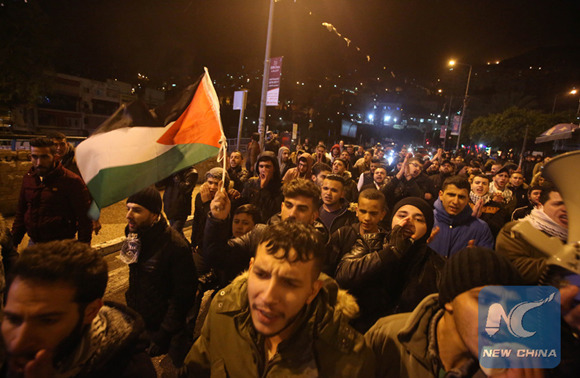 Palestinians take part in a protest against the U.S. decision to recognize Jerusalem as Israel's capital in the West Bank city of Nablus, on Dec 6, 2017. U.S. President Donald Trump's declaration on Wednesday to recognize Jerusalem as Israel's capital has drawn strong condemnation from the Arab states and the Islamic world. (Xinhua/Ayman Nobani)