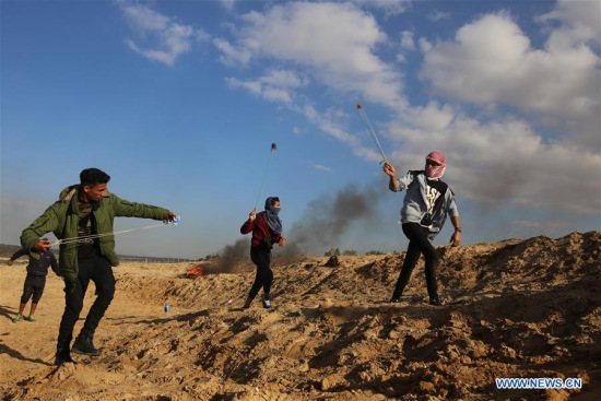 Palestinian protesters hurl stones at Israeli troops during clashes after a protest against U.S. recognition of Jerusalem as Israeli capital, in Khan Younis, southern Gaza Strip, on Dec. 8, 2017. (Xinhua/Khaled Omar)