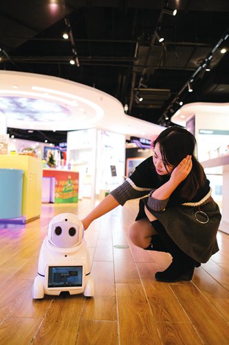 A customer interacts with a household robot in a high-tech product store. (Photo: Li Hao/GT)