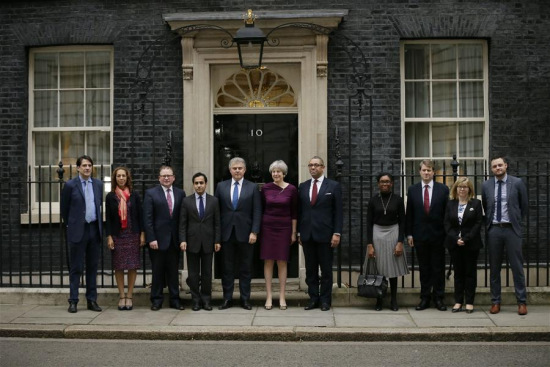 British Prime Minister Theresa May (C) poses for a picture outside 10 Downing street with Conservative Party Chairman Brandon Lewis (5th L) and Conservative Party Deputy Chairman James Cleverly (5th R), with Conservative vice chair members as she announces new ministerial appointments to her front bench in a Cabinet reshuffle beginning today, in London, Britain on Jan. 8, 2018. (Xinhua/Tim Ireland)