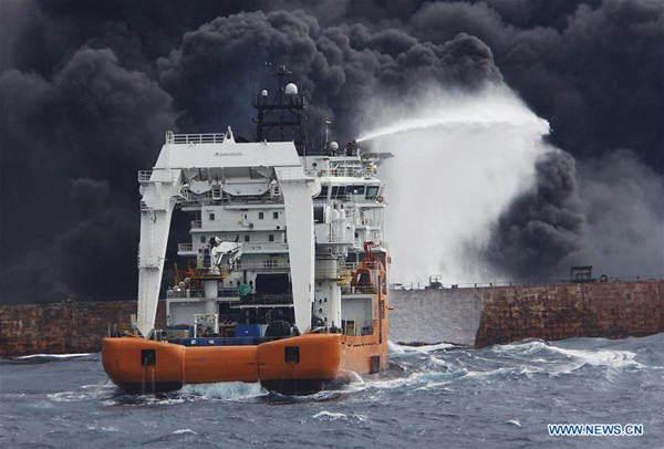 Rescuers spray foam to extinguish flames on the stricken oil tanker SANCHI off the coast of east China's Shanghai, Jan. 12, 2018. Shanghai Maritime Safety Administration said there is still a large fire on the Panama-registered oil tanker SANCHI. It is likely to explode and sink, the administration said at a press conference on Friday. (Xinhua)