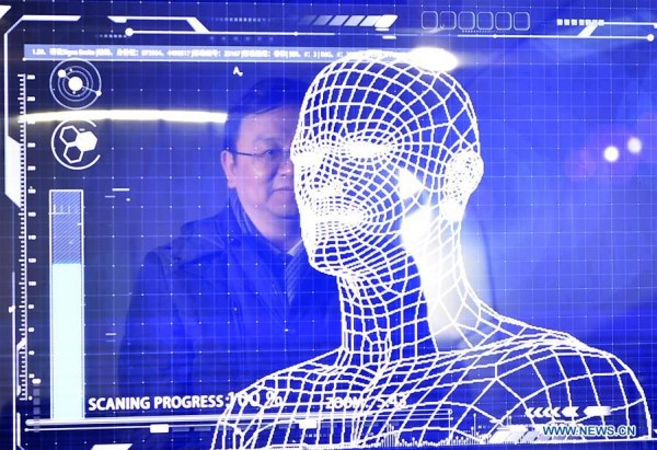 A manager of China's leading new energy vehicle maker BYD tries the facial recognition for starting a "Yungui" train during the launching of the "Yungui" system, a driverless monorail transit system, in Yinchuan, capital of northwest China's Ningxia Hui Autonomous Region, Jan. 10, 2018. (Xinhua/Wang Peng)