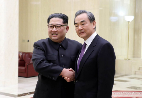 Kim Jong-un, top leader of the DPRK (left), meets with State Councilor and Foreign Minister Wang Yi in Pyongyang on Thursday. (Photo/Xinhua)