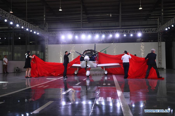 Special guests unveil an airplane GA20 in Nanchang, capital of east China's Jiangxi Province, May 21, 2018. The single-engine propeller-driven GA20 is a fixed wing four-seat civil utility aircraft, whose intellectual property is independently owned by a Chinese private enterprise Guanyi Aero. The plane rolled off the production line and finished its first runway test on Monday. (Xinhua/Zhou Mi)