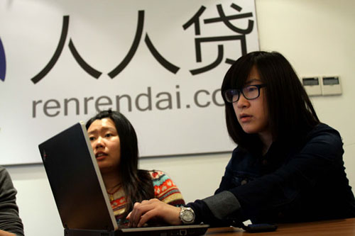 Zhao Nan (right) directs enterprise development for Renrendai, which operates a website that puts together small borrowers and lenders. The company says its business has been increasing 20 percent a month. Zhu Xingxin / China Daily 