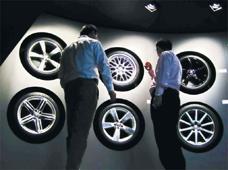 Visitors at a tire booth at an international auto exhibition in Shanghai. A number of Chinese exports, including tires, have become the subject of EU anti-dumping and anti-subsidy rulings, and industry experts said there may be more such cases in the futu