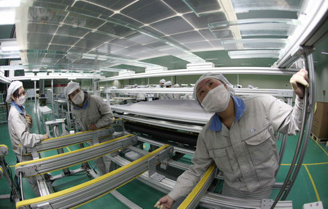 Workers in Lianyungang city, Jiangsu province, make solar panels for export to the US and Europe. Officials say it's likely the EU will investigate claims against Chinese makers of solar products. [Photo / China Daily]