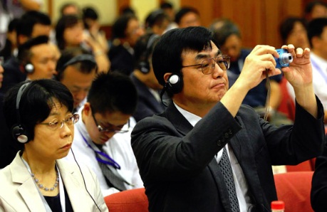 Kenji Hattori, a Japanese professor, takes pictures during a forum in Beijing to commemorate the 40th anniversary of both countries normalizing diplomatic relations on Wednesday. Zou Hong / China Daily