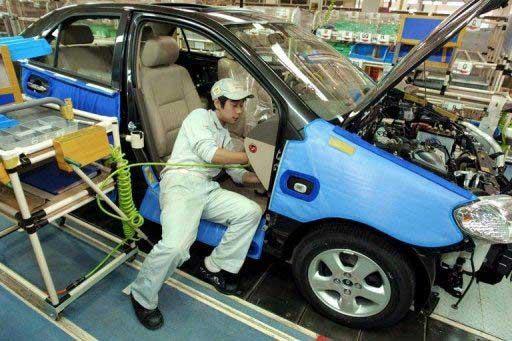 This file photo shows a worker installing parts to a Toyota vehicle at the Tianjin Toyota