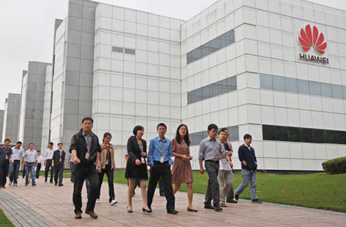 Employees of Huawei Technologies Co Ltd, the Chinese telecom equipment maker mentioned in the US congressional panel report, walk past the company office in Shenzhen, Guangdong. Tyrone Siu / Reuters