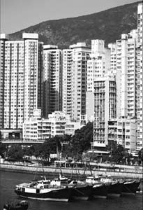 Residential buildings stand by Aberdeen harbor. As government accelerates land sales, the city's builders are pacing up their project development. Lam Yik Fei / Bloomberg 