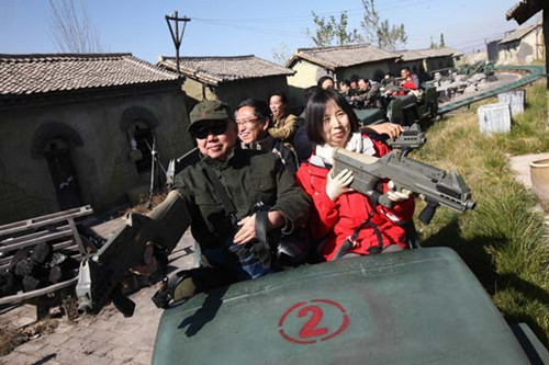 Tourists experience simulated warfare at the Eighth Route Army Culture Park in Wuxiang county, Shanxi province, in October. [Photo by Xu Chongde / for China Daily] 