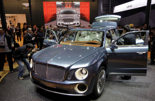 People take pictures of the EXP 9 F Bentley SUV concept car displayed at Auto China 2012 in Beijing on April 23. [Jason Lee / Reuters]