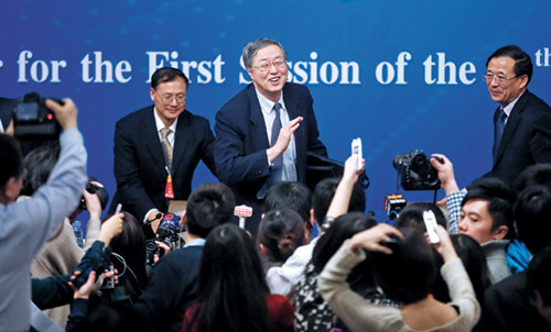 Zhou Xiaochuan, the central bank governor, still faces questions even after a news conference at the National People's Congress on Wednesday in Beijing. [Feng Yongbin/China Daily]