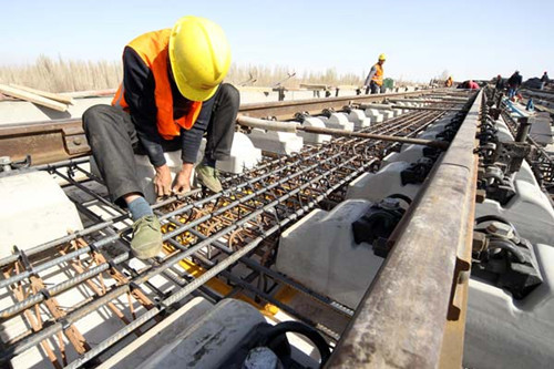 A worker at the construction site of a flyover in Hami, the Xinjiang Uygur autonomous region, in March. First-quarter data showed investment in some industries facing overcapacity, such as construction, had declined. CAI ZENGLE/FOR CHINA DAILY