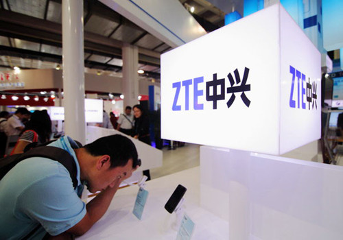 ZTE's mobile phone display at a telecommunications trade show in Beijing. The company booked a net loss of 2.84 billion yuan ($459 million) last year, from a net profit of 2.06 billion yuan in 2011. [Photo/China Daily]