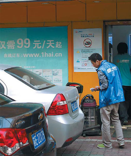 An employee checks cars at an eHi Car Service outlet in Shanghai in October 2010. [Photo/China Daily]