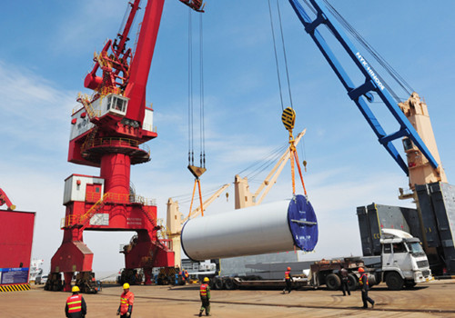 Workers load a wind energy generating system at Dafeng port in Jiangsu province, destined for Panama in Central America. Chinese manufacturers are increasingly building their presence in the emerging markets of Southeast Asia and Latin America. [Photo/China Daily]