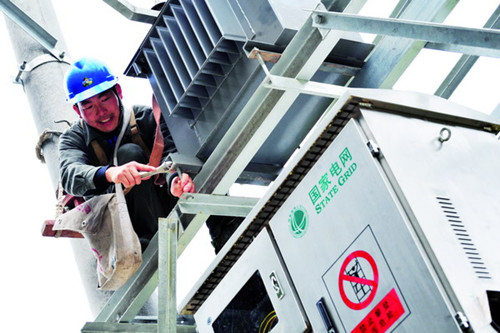 A employee of State Grid, China's largest power distributor, works on electrical equipment in Yichang, Hubei province. [Photo/China Daily]