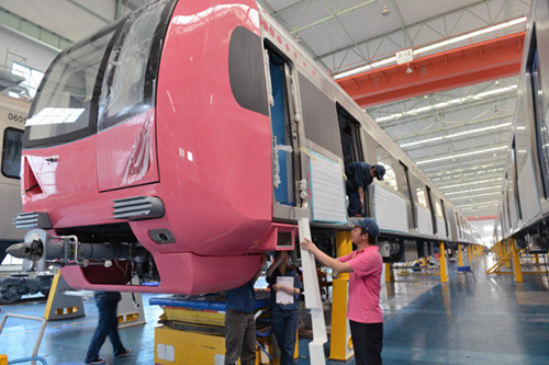 Workers assemble subway cars at a manufacturing plant in Chongqing. The country's industrial output growth speeded up in April to 9.3 percent year-on-year, compared with 8.9 percent in March. [Photo/China Daily]