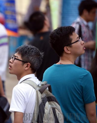 Job seekers look around at a job fair at Nanchang University in Jiangxi province on May 23.