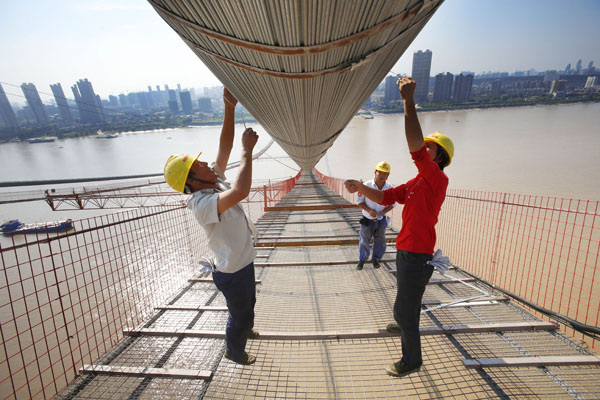 A bridge over the Yangtze River under construction in Wuhan, Hubei province. It will be the eighth Yangtze River bridge in the city and is evidence of ongoing infrastructure development. The country is making preparations for drafting the next five-year economic development plan (2016-20), which may put emphasis on boosting domestic demand.CHEN ZUO/FOR CHINA DAILY