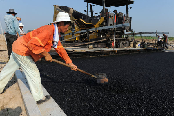 A road under construction in Bozhou, Anhui province. The central government will increase investment in such projects to improve living standards and upgrade cities' infrastructure. Railway construction will also be accelerated in the second half.ZHANG YANLIN/FOR CHINA DAILY