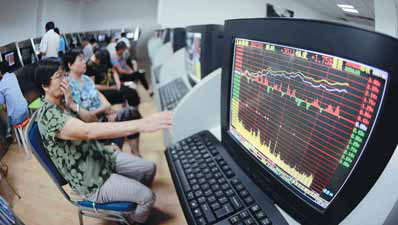 Investors conduct stock transactions at a brokerage office in Qingdao, Shandong province. An optimistic economic outlook and upbeat data helped push the benchmark Shanghai Composite Index up 1.9 percent to close at 2,096.74 points on Monday. Yu Fangping/for China Daily