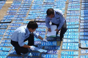 Policemen in Ningbo, Zhejiang province, register car license plates on Monday, that were found after part of the city flooded after a storm brought by Typhoon Fitow last week. More than 500 plates have still to be collected by their owners. Zhang Peijian / Xinhua