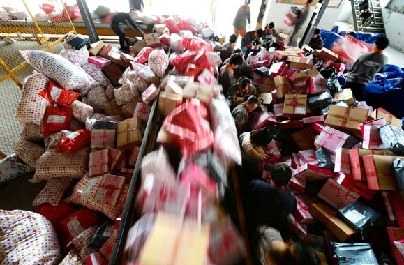 Goods for delivery pile up at a distribution center for courier company Shentong Express in Yangzhou, Jiangsu province, on Monday. Meng Delong / China Daily  