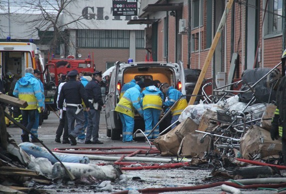 Firemen work at the factory which got fire in Prato, Italy, Dec. 1, 2013. At least seven Chinese people were killed and two others were injured in a factory fire in central Italy on Sunday, local media reported. (Xinhua/Alberto Lingria)