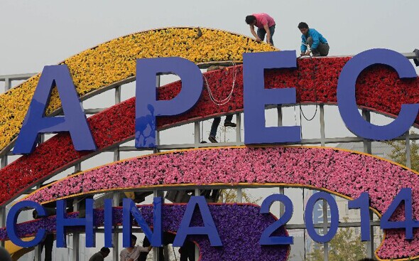 Workers set up a flower decoration for the upcoming APEC meeting in Xidan of Beijing, Oct 25, 2014. The APEC Economic Leaders' Meeting will be held in Beijing from Nov 10 to 11. The APEC leaders' week also includes the final senior officials' meeting from Nov 5 to 6 and the 26th ministerial meeting from Nov 7 to 8. [Photo/Xinhua]   