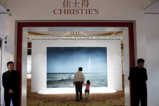 Security guards stand at the doors as people look at Jia Aili's Nameless Days 2 during a media preview of Christie's Shanghai Spring Auction in Shanghai on April 23. (Photo/China Daily)