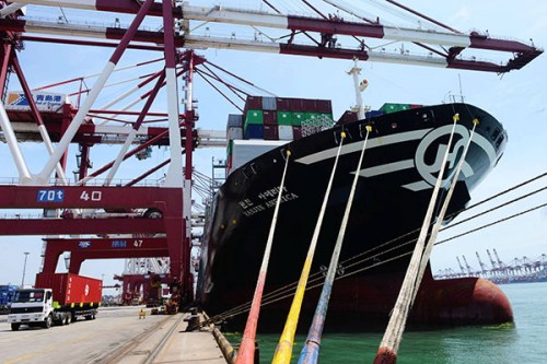 A container ship is being loaded at a dock in Qingdao, Shandong province, on Saturday. China's foreign trade was valued at about 2.07 trillion yuan ($333 billion) in June. (Photo/China Daily)