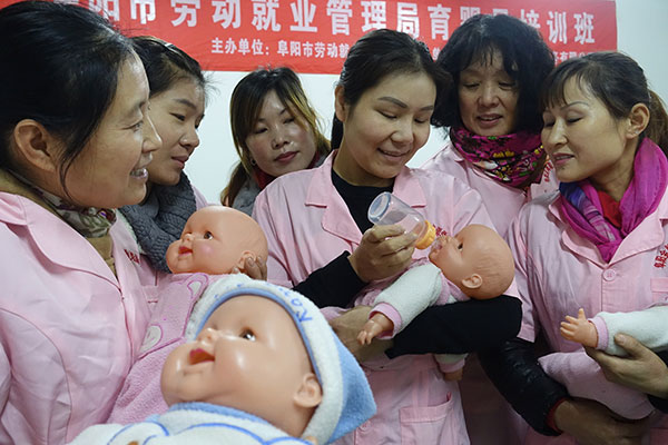 Babysitters attend a training class in Fuyang, Anhui province, in November. The babycare business is becoming an increasingly hot sector in China since the country proposed putting an end to the decades-old one-child family planning policy in late October. Wang Biao / for China Daily