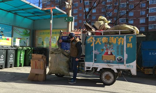 A Taoqbao employee collects recyclables in Beijing's Haidian district on Sunday. (Photo: Zhang Ye/GT)