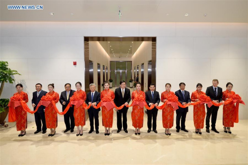 Delegates cut the ribbon for the opening of the headquarters building of the Asian Infrastructure Investment Bank (AIIB) in Beijing, capital of China, Jan. 17, 2016. The China-initiated multilateral bank started operational on Jan. 16. (Photo: Xinhua/Li Xin)