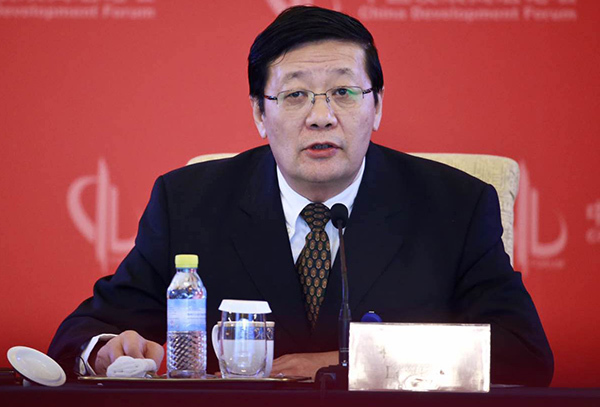 China's Finance Minister Lou Jiwei speaks at the China Development Forum in Beijing on Sunday. (Photo by Feng Yongbin/China Daily)