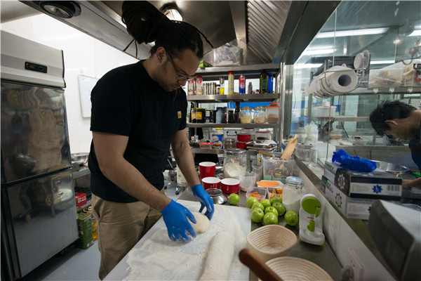 Baker Jonathan Ellis experiments with recipes at the shared kitchen facilities of The Hatchery in Beijing.BRUNO MAESTRINI/CHINA DAILY