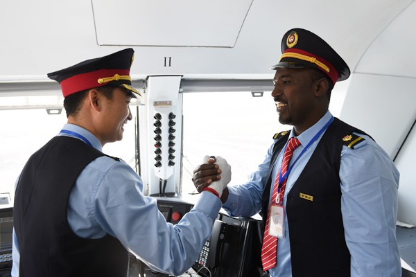 Chinese and Ethiopian train drivers shake hands, celebrating a railway station operational in Addis Ababa. (Photo/Xinhua)