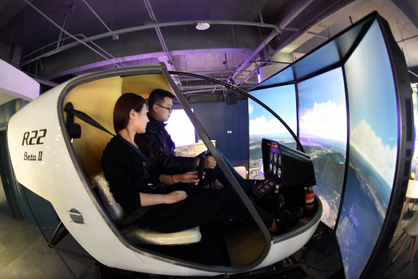 Working staff operate a flight simulator at the virtual reality technology center of the service outsourcing industry base in Langfang, Hebei province. (Photo/Xinhua)