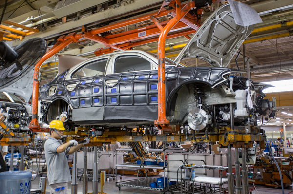 A worker at the car production line of FAW-Volkswagen in Changchun, capital of Jilin province. (Photo by Zhu Wanchang/For China Daily)