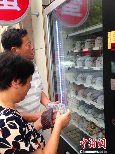 Shoppers buy crabs from the vending machine in Hangzhou.[Photo: Chinanews/ Li Chenyun]