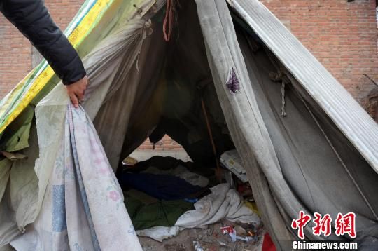 A tent in a cemetery in Henan province where a 70-year-old man has lived for four years. [Photo: Zhou Xiaoyun]