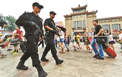 Armed special police patrol a railway station in Bejing. [Photo: the Beijing Youth Daily]
