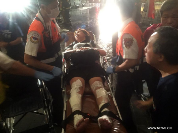 Rescuers transfer an injured person after an explosion of a commuter train in Taipei, southeast China's Taiwan, July 7, 2016. (Photo/Xinhua)