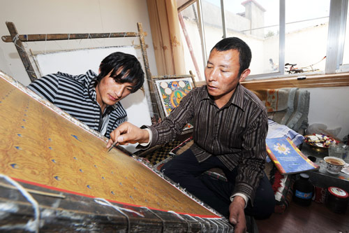 Zekyid learns thangka painting from his teacher Phuntso Dorje at Pandedajie School in Lhasa.