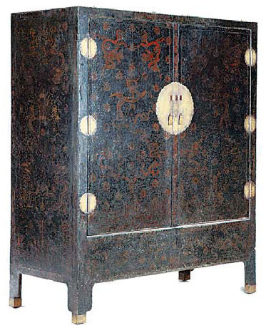 A cabinet with black lacquer and golden lotus flower patterns.