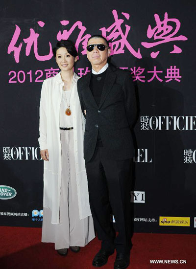 Feng Xiaogang (R), a famous Chinese director, and his wife Xu Fan, a Chinese actress attend china elegance ceremony held in the Water Cube, or the Beijing National Aquatics Center in Beijing, capital of China, Oct 25, 2012.[Photo/Xinhua]